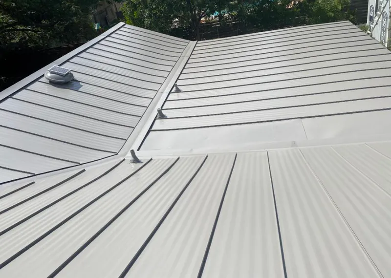 Solar attic fan installed on a metal roof for Roof Ventilation in Carolina Forest